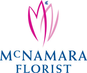 McNamara Florist's logo has the outline of a pink flower, with many petals, and a blue stamen, with the blue text, 'McNamara Florist' under the flower.